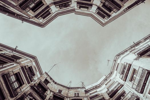 A unique low-angle view of Barcelona architecture emphasizing height and symmetry.