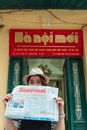 Woman in Brown Hat Holding White Newspaper