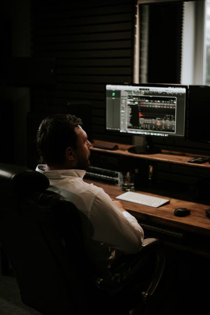 Businessman focused on work, analyzing data on dual monitors in tech office. - The 2026 Data & AI Specialist CV: Framing Pipelines, Models, and Business Value