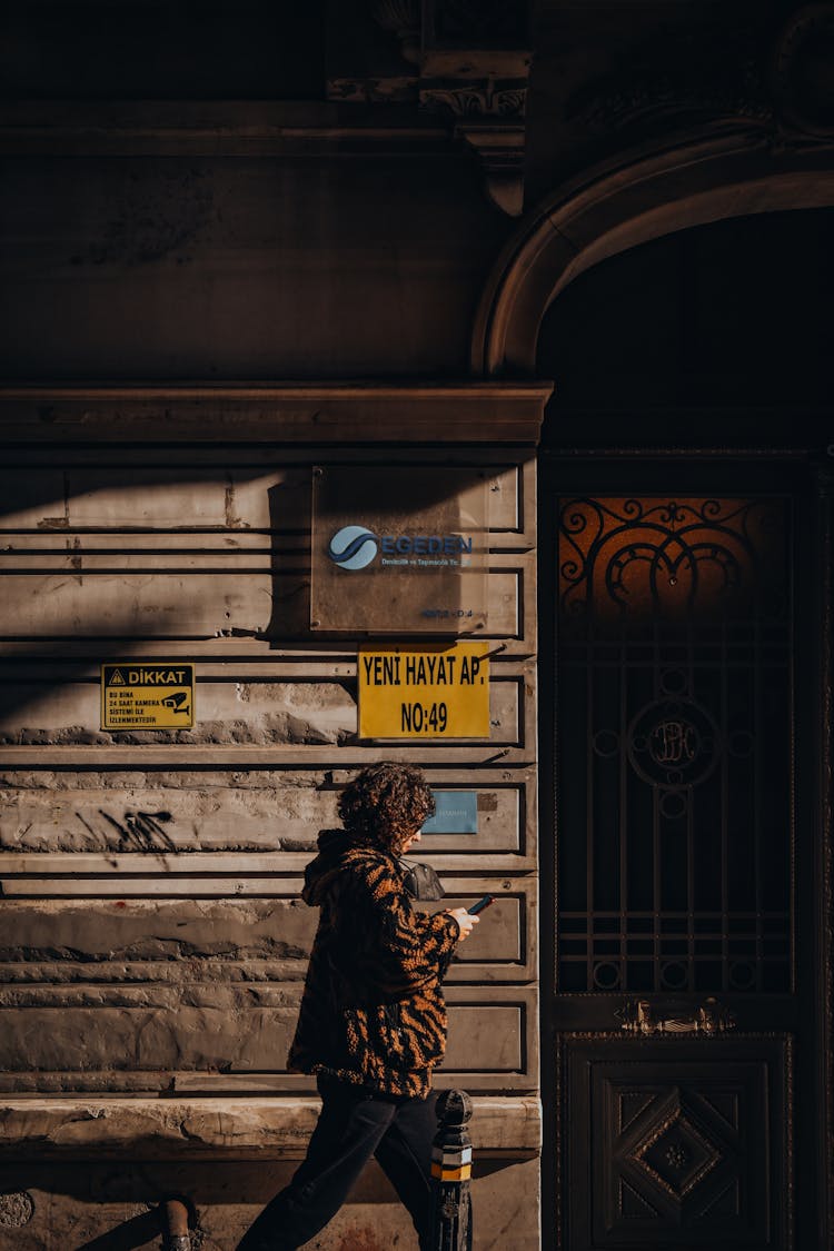 Person Using Cellphone While Walking