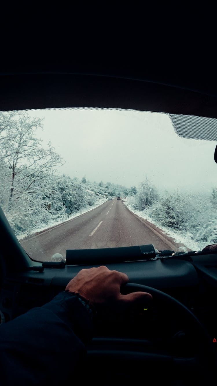 Man At Steering Wheel Driving Winter Road