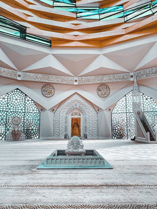 Free Explore the modern design and architecture of a beautifully lit mosque interior. Stock Photo