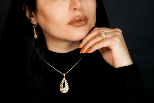 Close-Up Shot of a Woman in Gold Jewelries