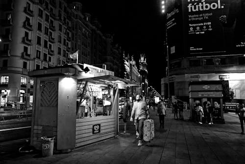 Free 
A Grayscale of a Store in a City at Night Stock Photo