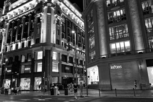 
A Grayscale of Buildings in a City at Night