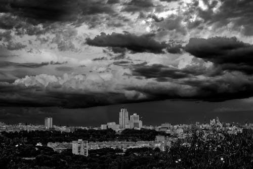 
An Aerial Shot of Tall Buildings in a City under a Cloudy Sky