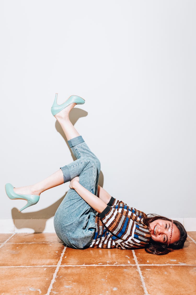 Woman In Blue Denim Shorts And Green Leather Pumps