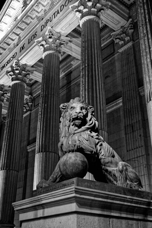 Grayscale Photo of a Lion Statue