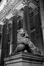 Grayscale Photo of a Lion Statue