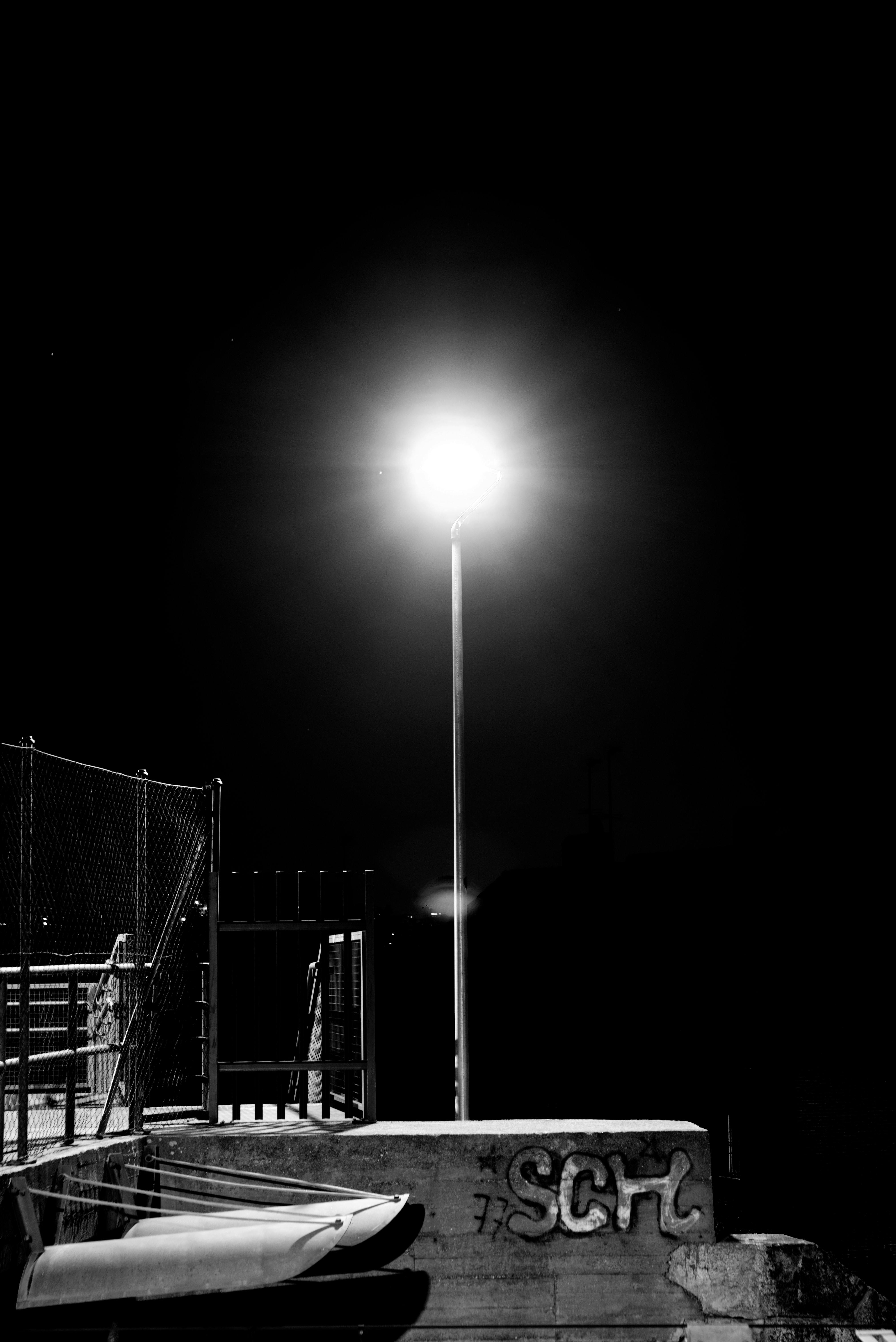 grayscale photo of a light post