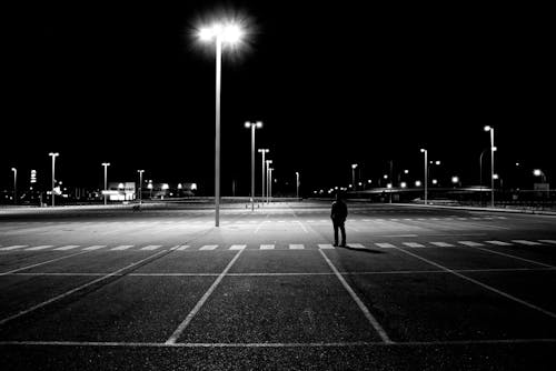 Free Man Standing on the Empty Parking Lot Stock Photo