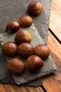 Brown Round Fruit on Gray Wooden Table