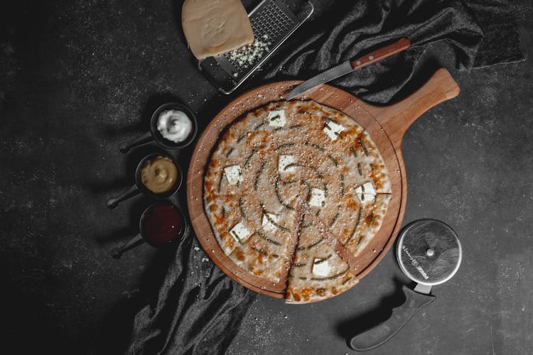 Pizza And Sauces On Table