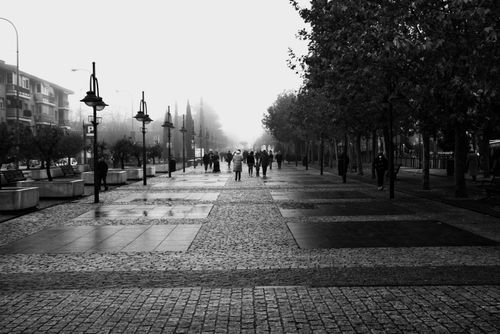 Free A misty urban street scene in Majadahonda, capturing people walking amidst foggy atmosphere. Stock Photo