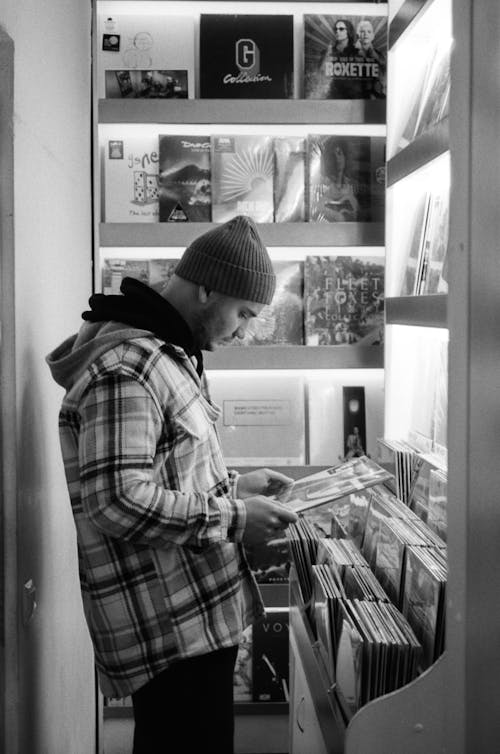 Man in Music Shop Buying Vinyl Record