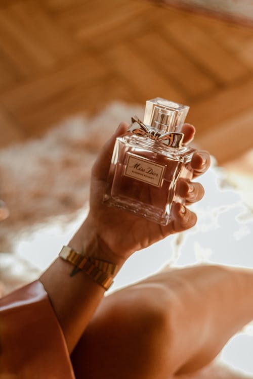Shallow Focus of a Person Holding a Perfume Bottle