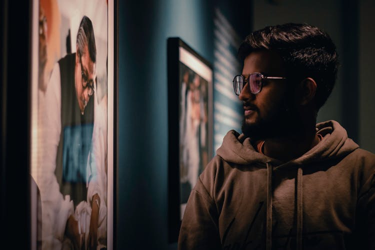 Man Looking At Framed Photography At An Exhibition