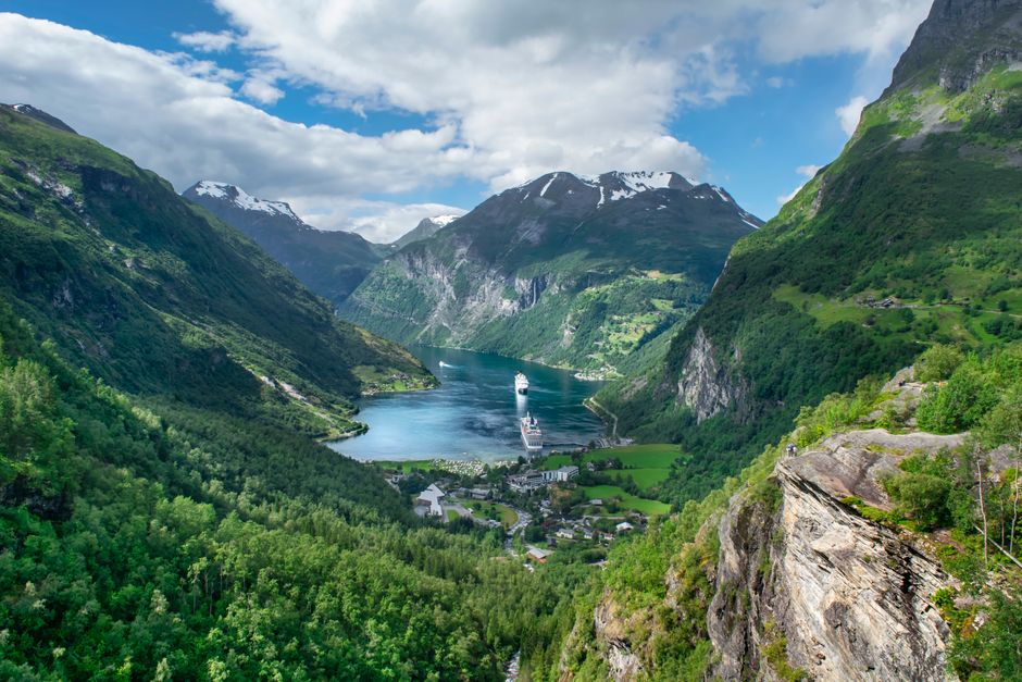 Tourist boat cruising through the stunning Geirangerfjord in Norway