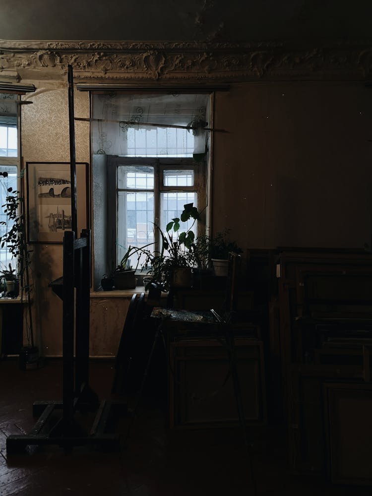 Stack Of Folding Chairs And Tables In A Dark Room