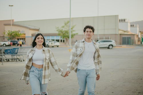 Free Couple Holding Hands on Car Park Stock Photo