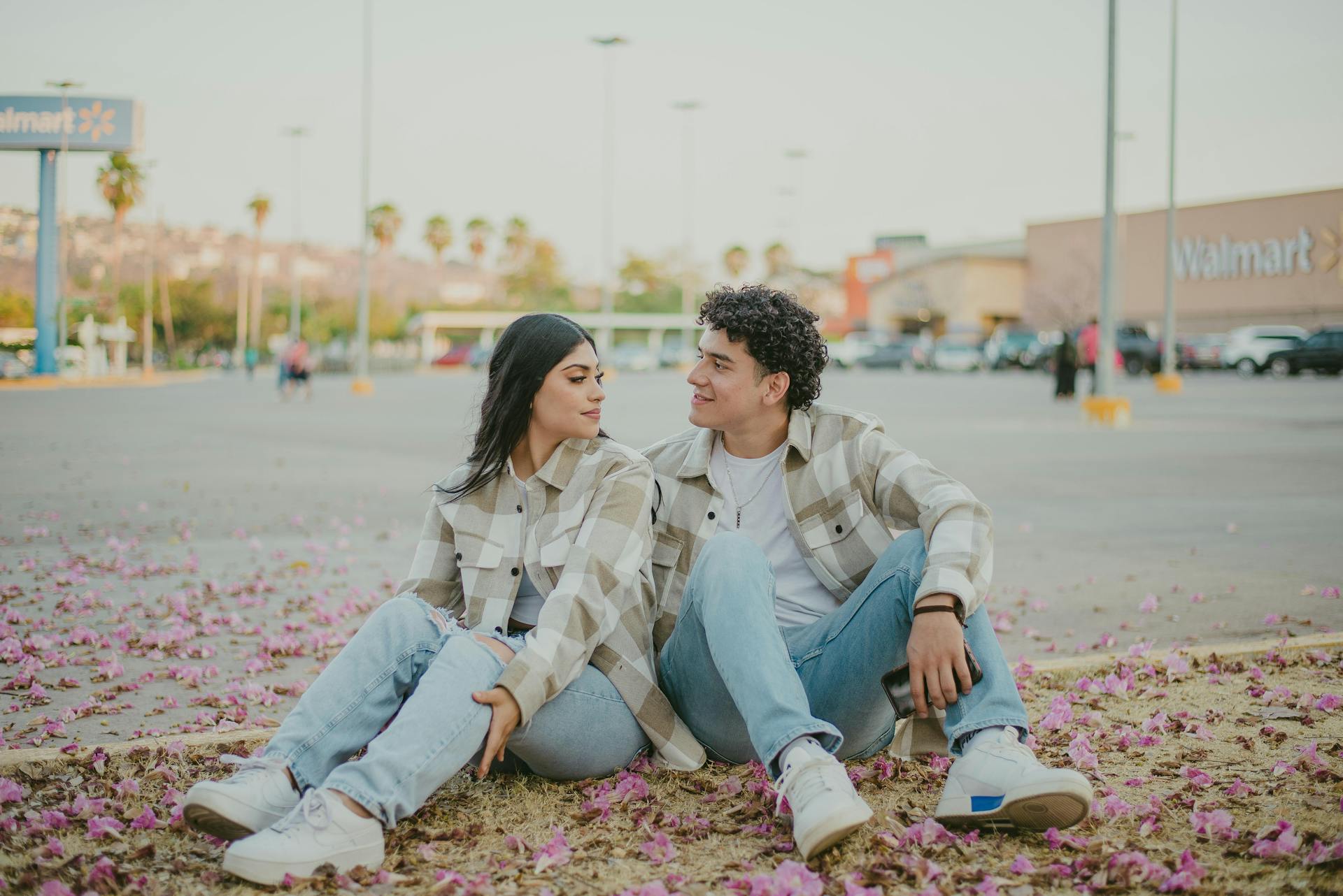 Couple Sitting by Flowers on Walmart Car Park