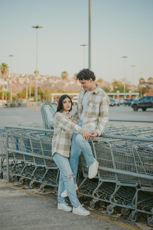 Free Couple on Shopping Carts on Car Park Stock Photo
