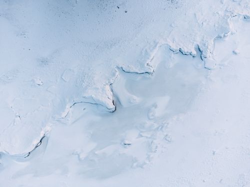 Free A stunning aerial view of a frozen landscape showcasing intricate ice formations under winter light. Stock Photo