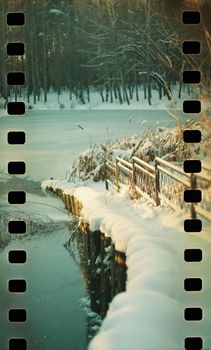 Peaceful winter scene with a snow-covered bridge by a frozen lake.