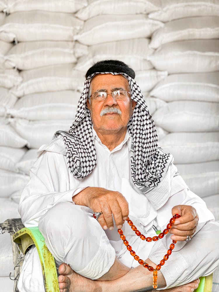 Old Man In Traditional Arabic Clothes With Rosary 