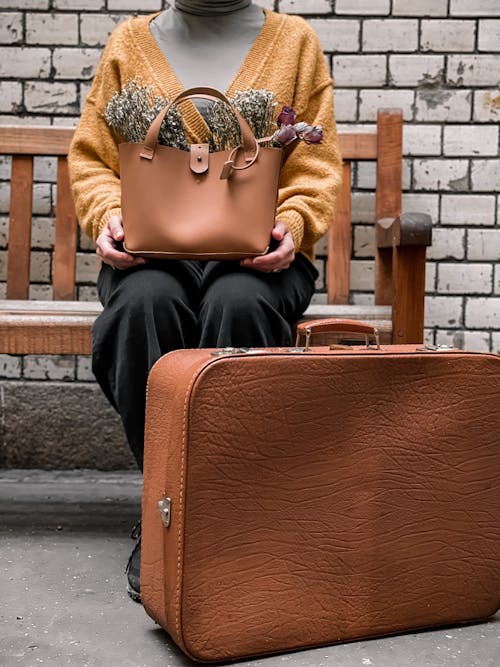 Woman Holding a Brown Leather Bag