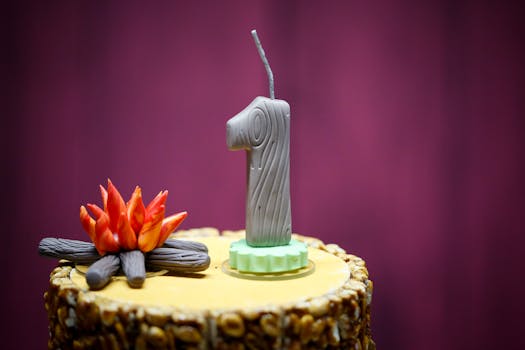 Rustic themed cake with a log-style candle for a one-year celebration against a violet backdrop.