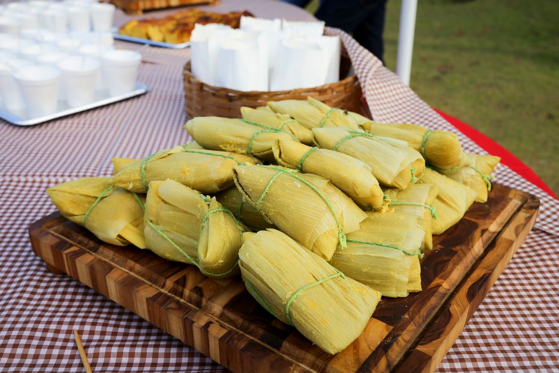 Tamales on a wooden tray