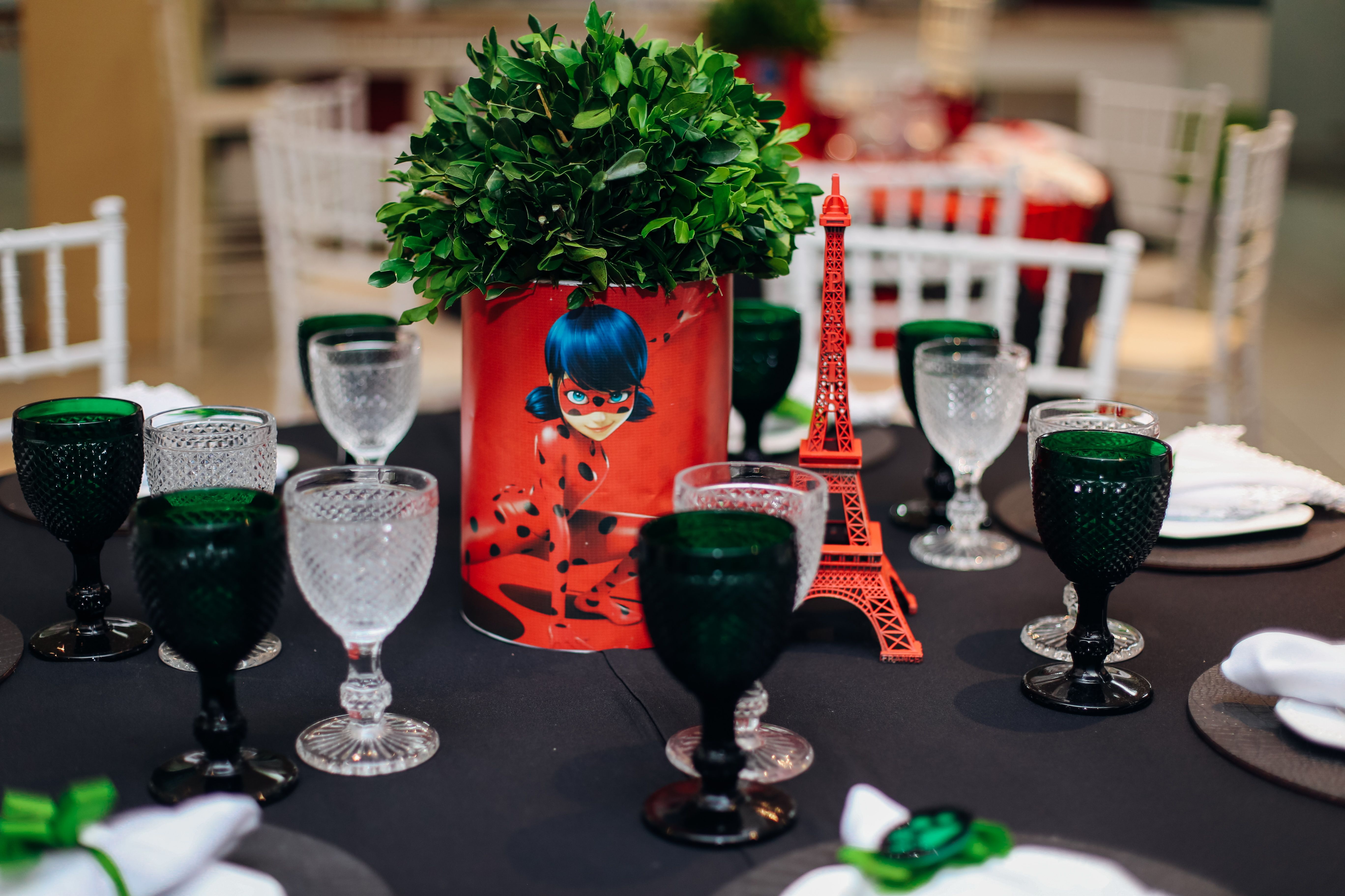 Beautifully set table featuring Eiffel Tower centerpiece, perfect for a Paris-themed event.