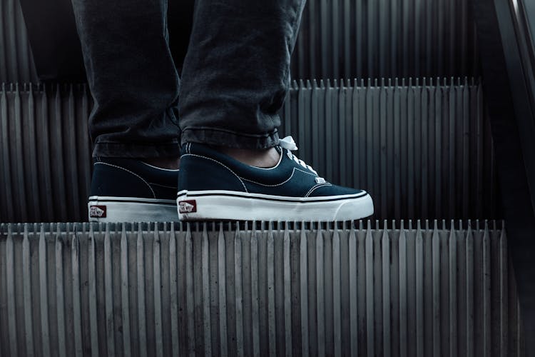 Man Feet In Sneakers On Elevator