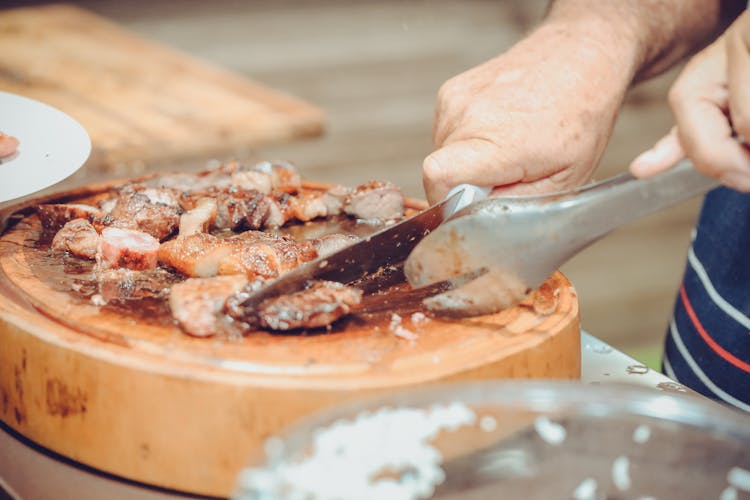 Person Slicing Meat