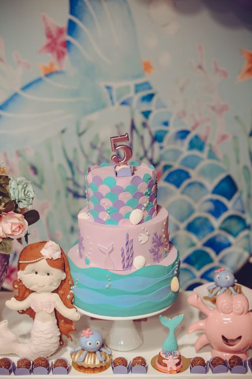 Mermaid-themed birthday cake decorated with ocean elements for a child's fifth birthday celebration