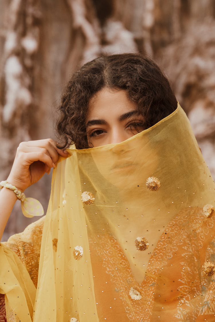 Woman Covering Face With Yellow Shawl