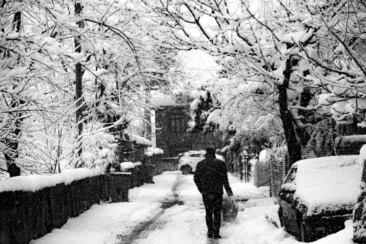 Man Walking Street In Snow In Winter