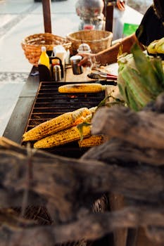 Delicious grilled corn on a vendor's grill in Greece, perfect for street food enthusiasts.