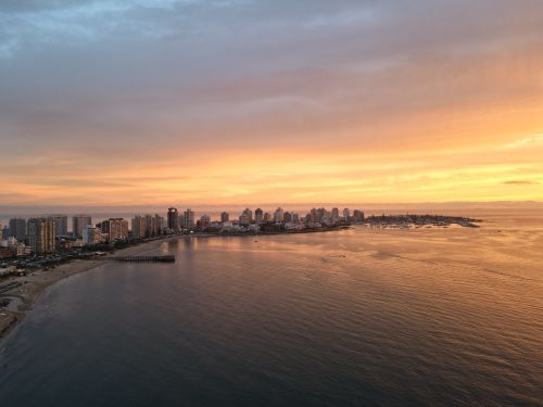 Free Stunning drone view of Punta del Este skyline and coastline during a vibrant sunset. Stock Photo