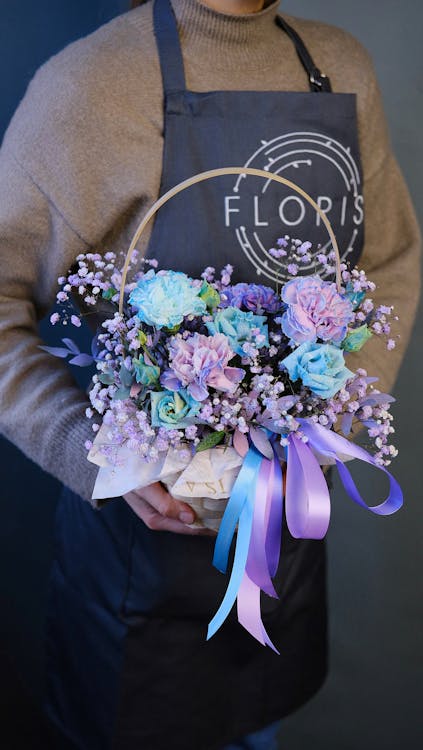 Free Florist Holding Basket of Flowers Stock Photo