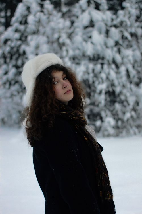 Free Elegant woman in white hat and winter clothing in snowy forest, showcasing the beauty of winter fashion. Stock Photo