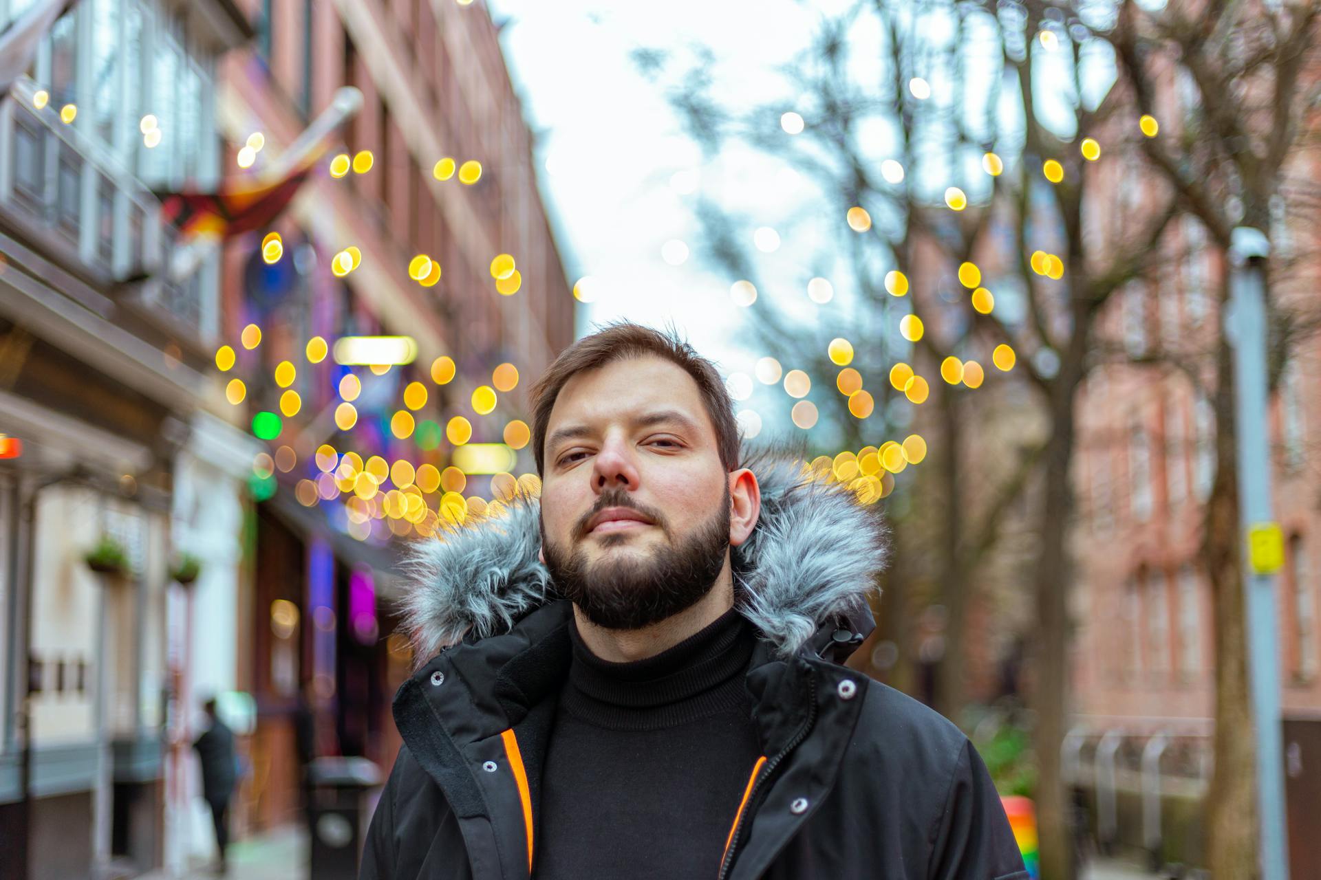 Man Wearing Black Coat with Fur