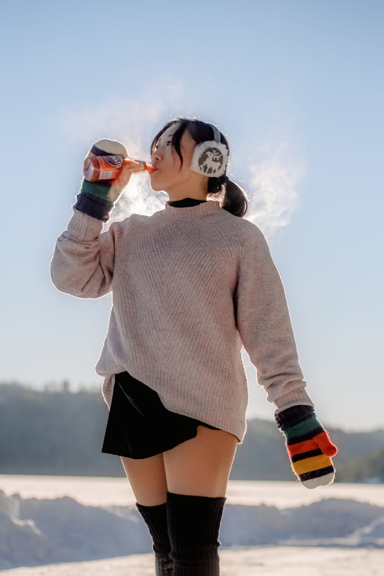 Woman Drinking On Snow