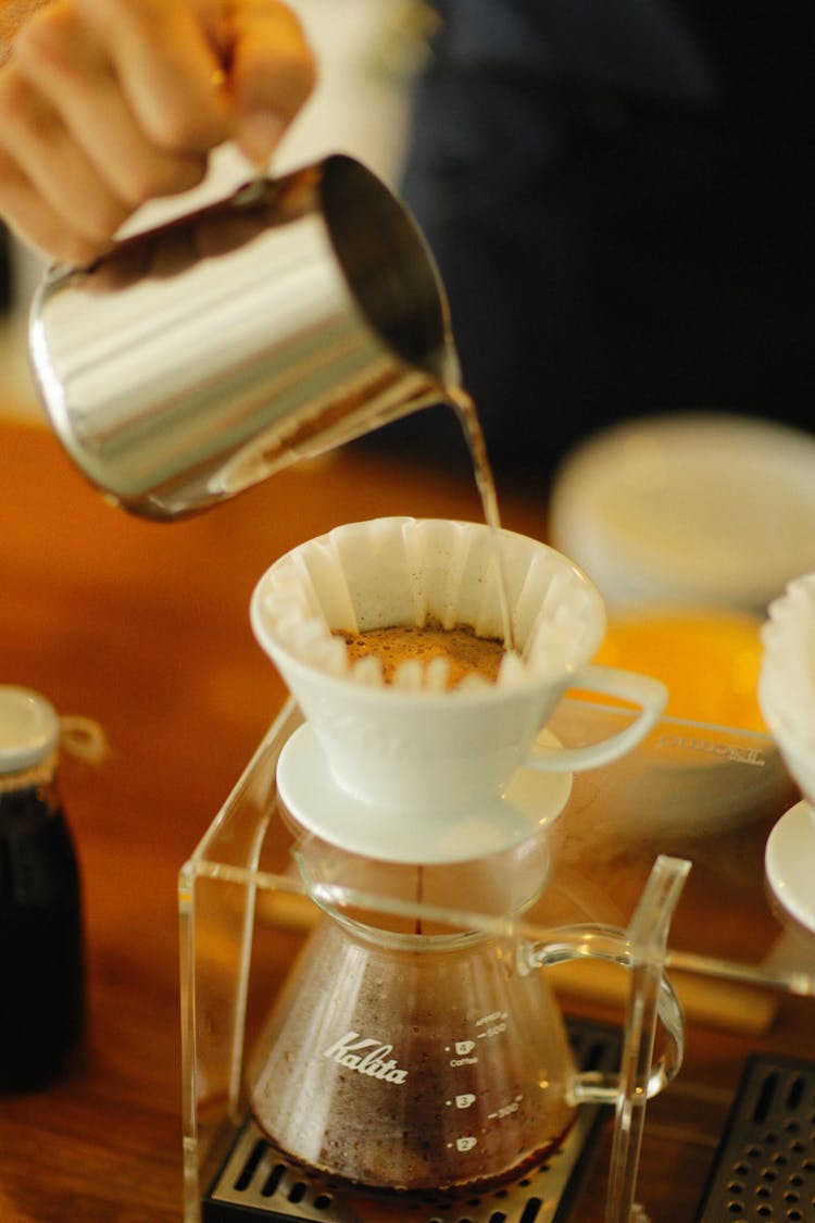 Man Hand Pouring Water And Making Coffee