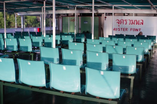 Image of empty seating area with teal chairs in a muster point.