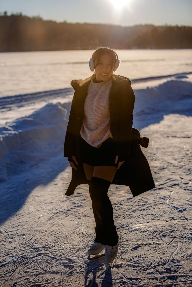 Woman Ice Skating On Frozen Lake