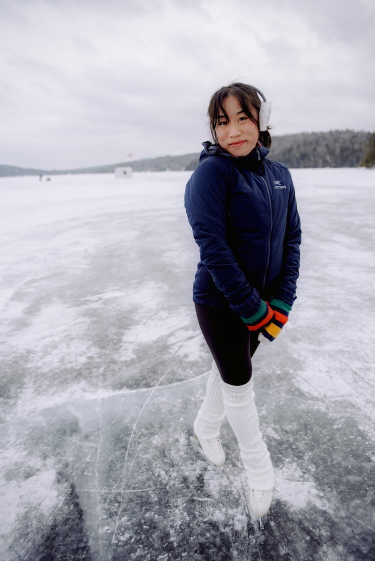 Woman Ice Skating On Frozen Lake