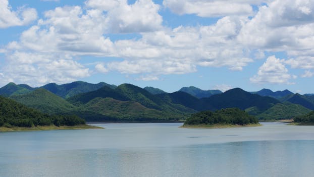Serene landscape of a lake and mountains in Phetchaburi, Thailand.