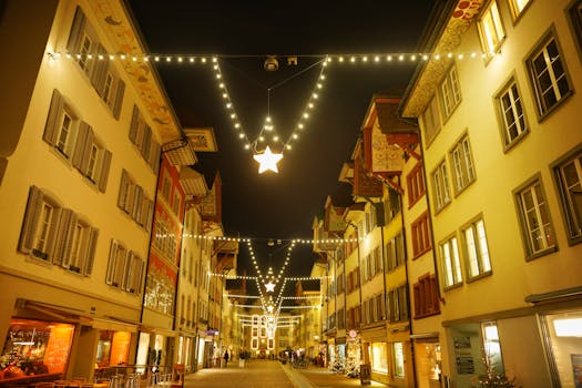 A beautifully decorated street with enchanting Christmas lights and elegant buildings at night.
